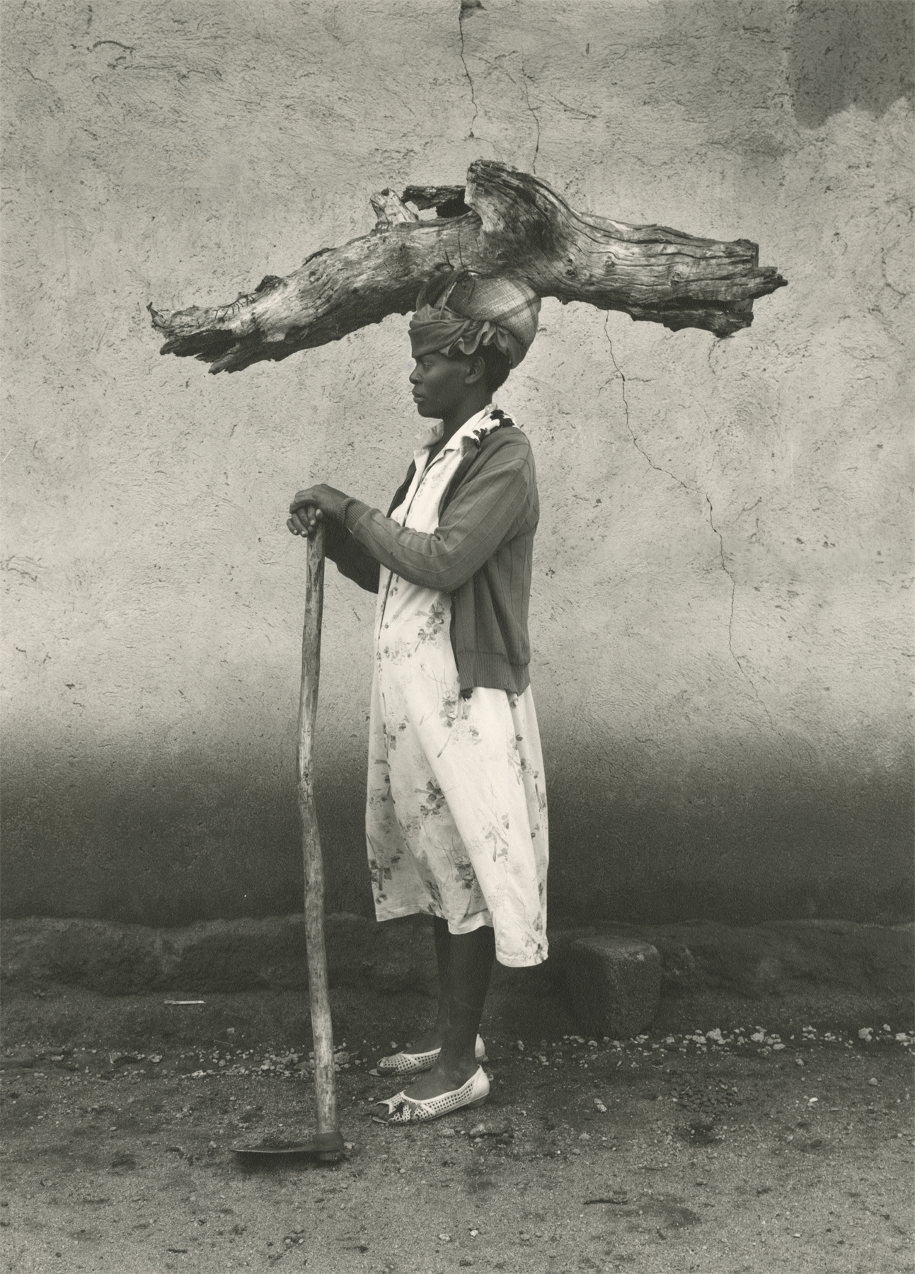 Nadav Kander  Lady with Log, South Africa, 1991  Gelatin silver print; printed 1991  14 3/8 x 10 3/8 inches