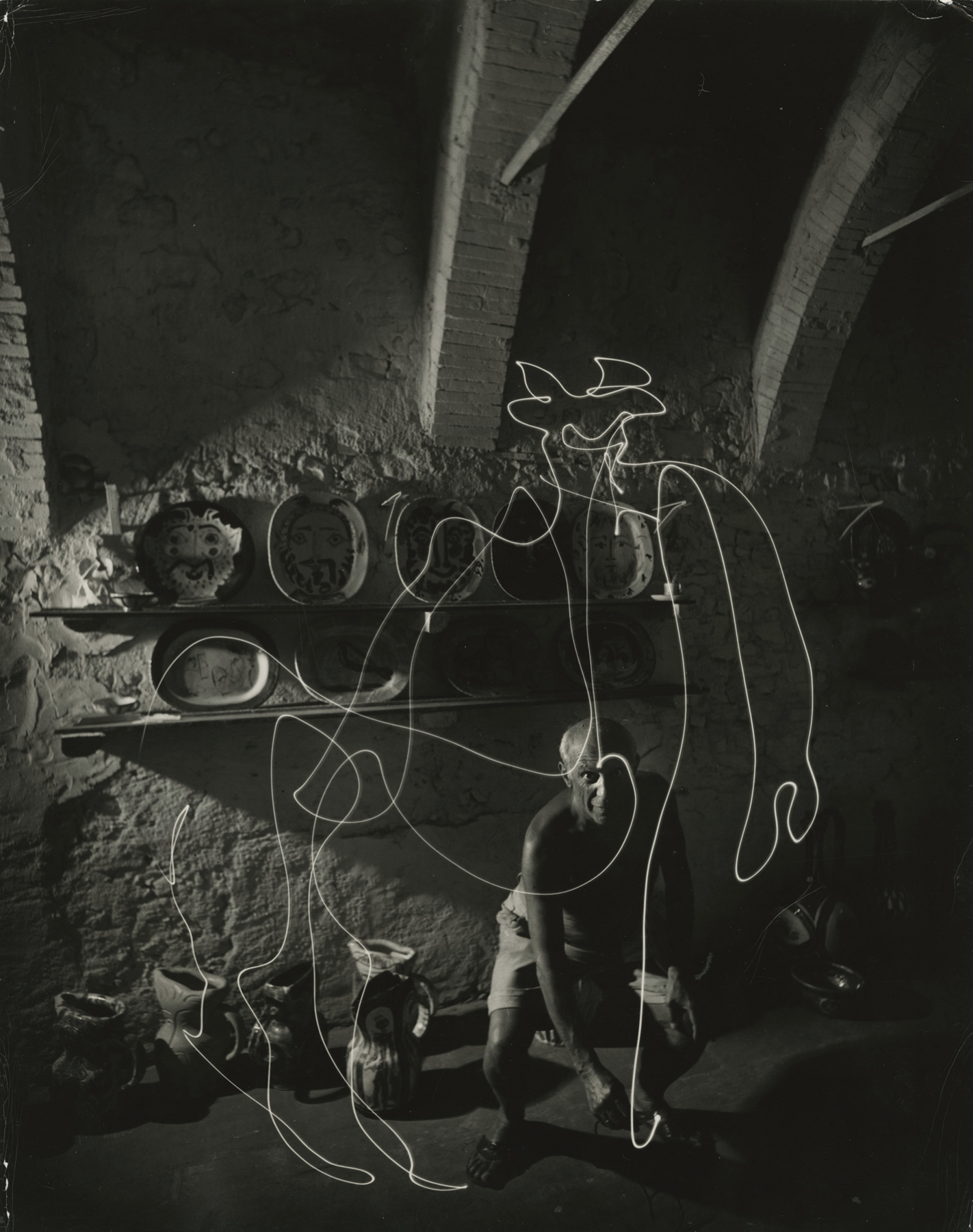 Pablo Picasso &quot;painting&quot; with light at the Madoura Pottery, Vallauris, France, 1949